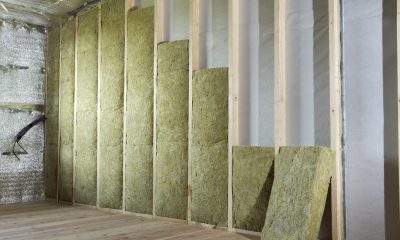 Wooden frame for future walls insulated with rock wool and fiberglass insulation staff for cold barrier. Comfortable warm home, economy, construction and renovation concept.