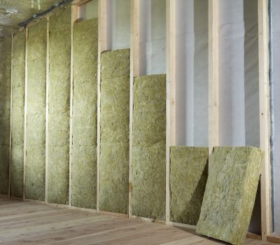 Wooden frame for future walls insulated with rock wool and fiberglass insulation staff for cold barrier. Comfortable warm home, economy, construction and renovation concept.